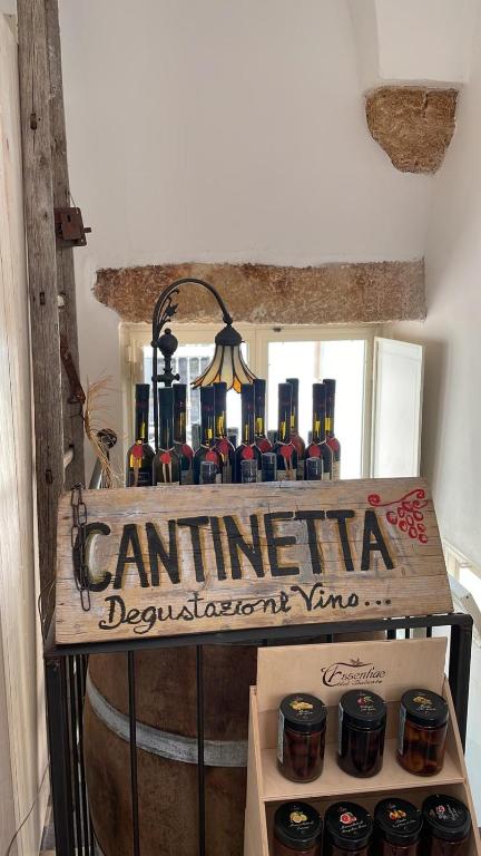 a bunch of bottles of wine on top of a barrel at CORTE LARGO LAURO DIMORE & SPA in Gemini