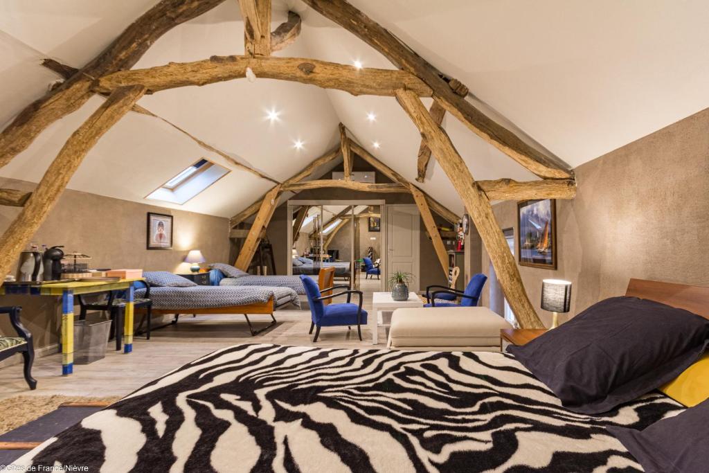a room with a zebra rug on the floor at La mansarde des Sources in Pougues-les-Eaux