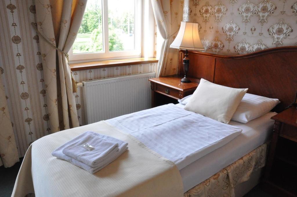 Posteľ alebo postele v izbe v ubytovaní Hotel MERTIN