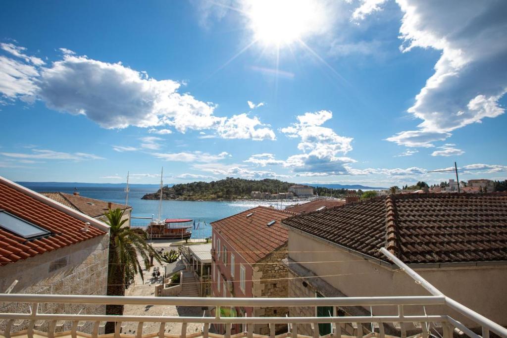 a view of the ocean from the roofs of buildings at City Centar Apartments in Makarska