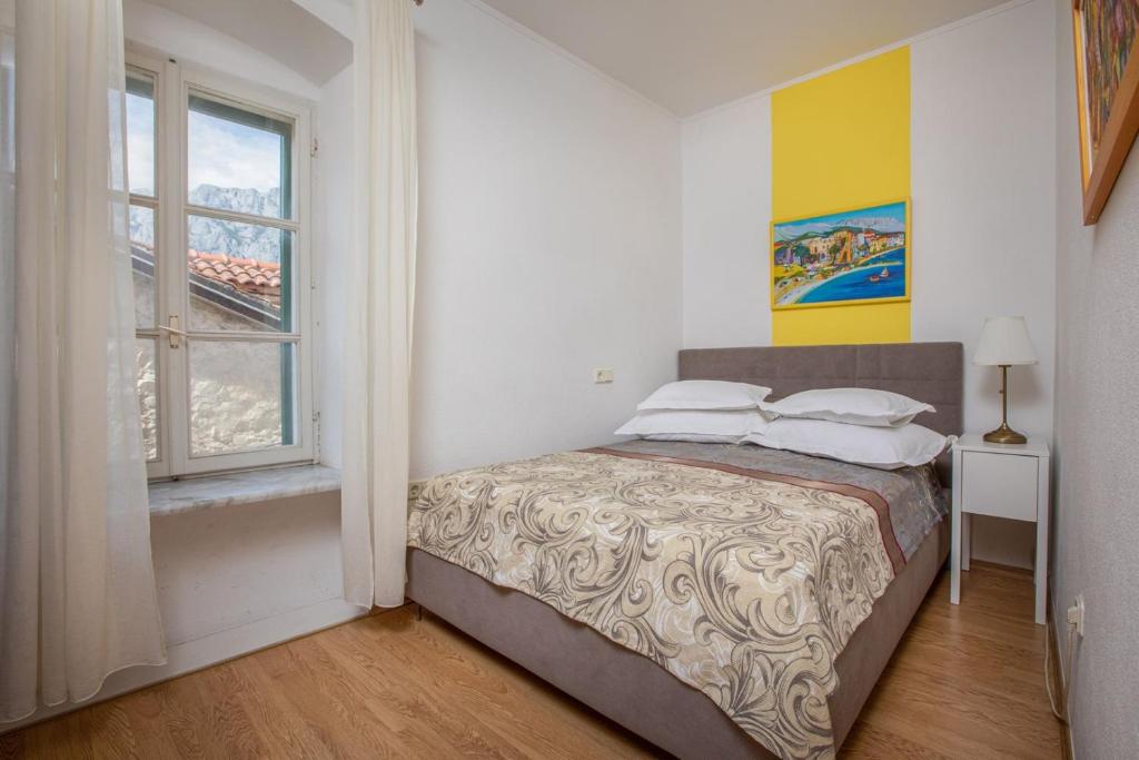 Łóżko lub łóżka w pokoju w obiekcie City Centar Apartments