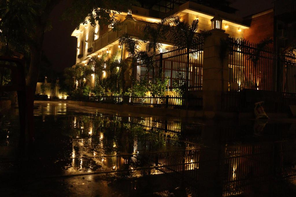 a building with lights in the rain at night at The Stoneberry Resort in Madhupur