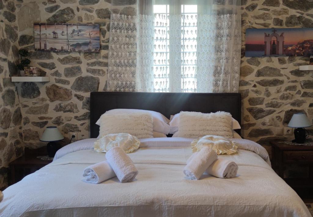 a bedroom with a large bed with towels on it at Marios guesthouse Pelion in Tsagarada