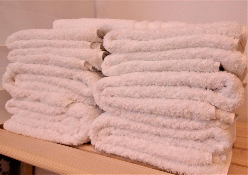a pile of towels sitting on a shelf at Ishel Trafalgar in Zahora