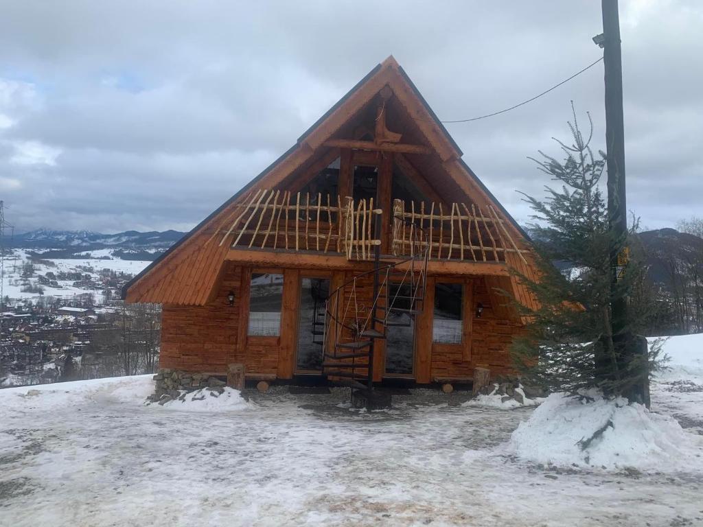 a log cabin on top of a snow covered hill at Rochowa Buznica in Zakopane