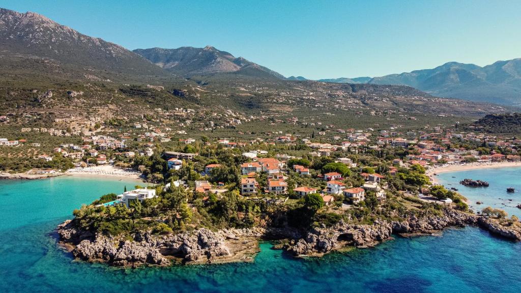 an aerial view of a small island in the ocean at Dimitra's Studios in Stoupa