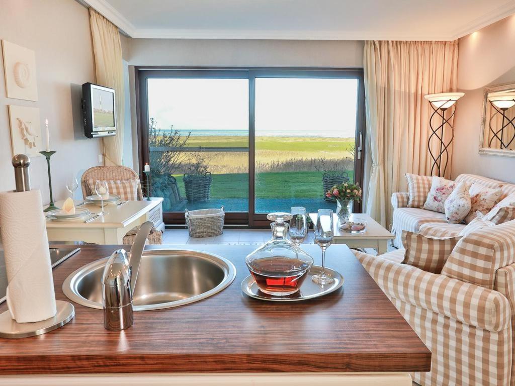 a kitchen with a sink with wine glasses on it at Sylt Cottage in Morsum