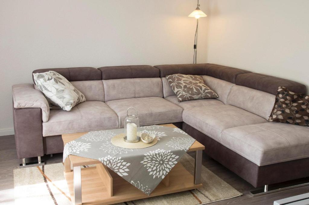 a living room with a couch and a coffee table at Haus-Frauenpreiss-Whg-52 in Cuxhaven