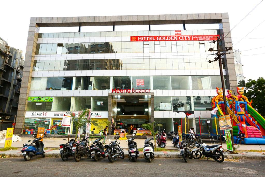 a group of motorcycles parked in front of a building at HOTEL GOLDEN CITY in Surat