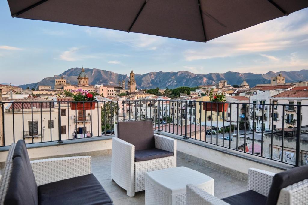 a balcony with a view of a city at Mercede Rooms in Palermo