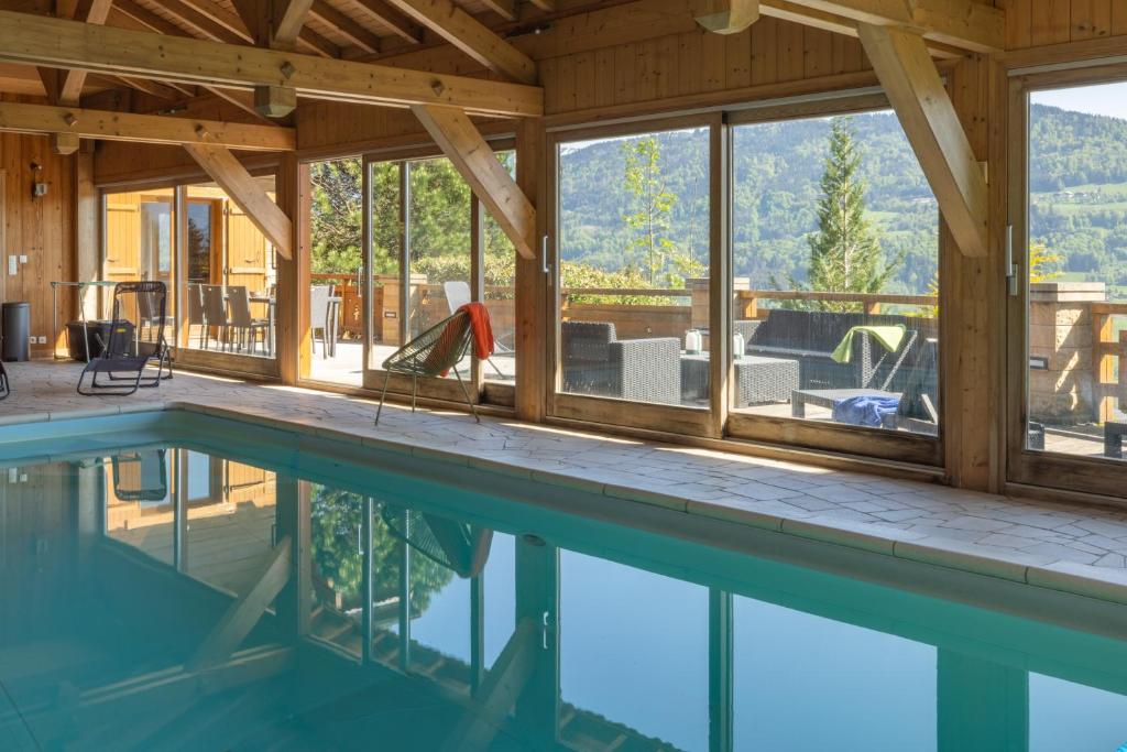 a pool house with a view of the mountains at Chalet Taninges in Taninges