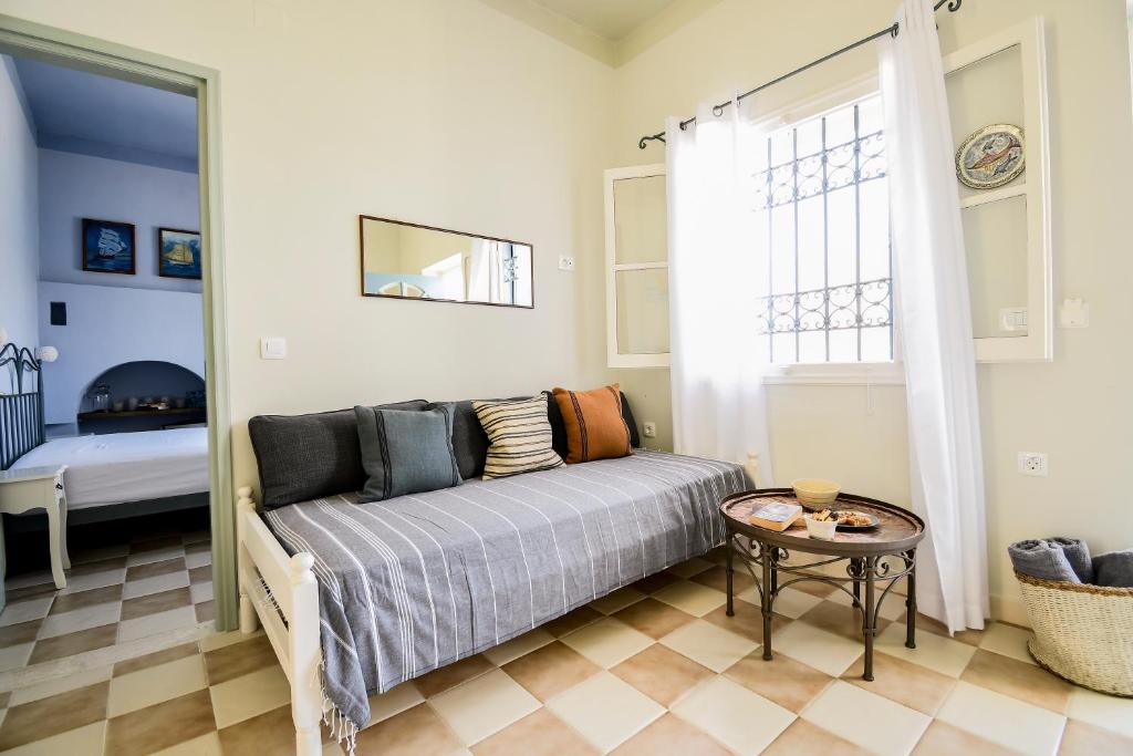 a living room with a couch and a table at Ponente in Symi
