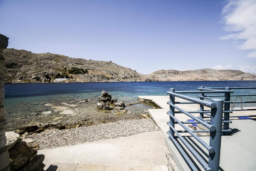a blue fence next to a body of water at Ponente in Symi