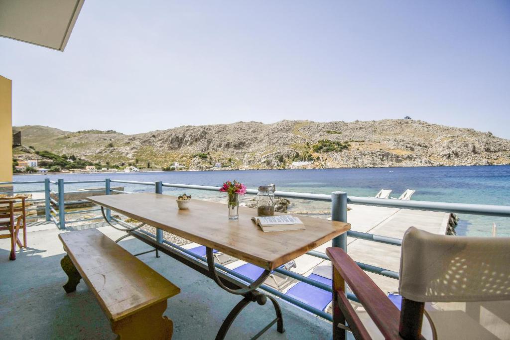 a table on a balcony with a view of the water at Ponente in Symi