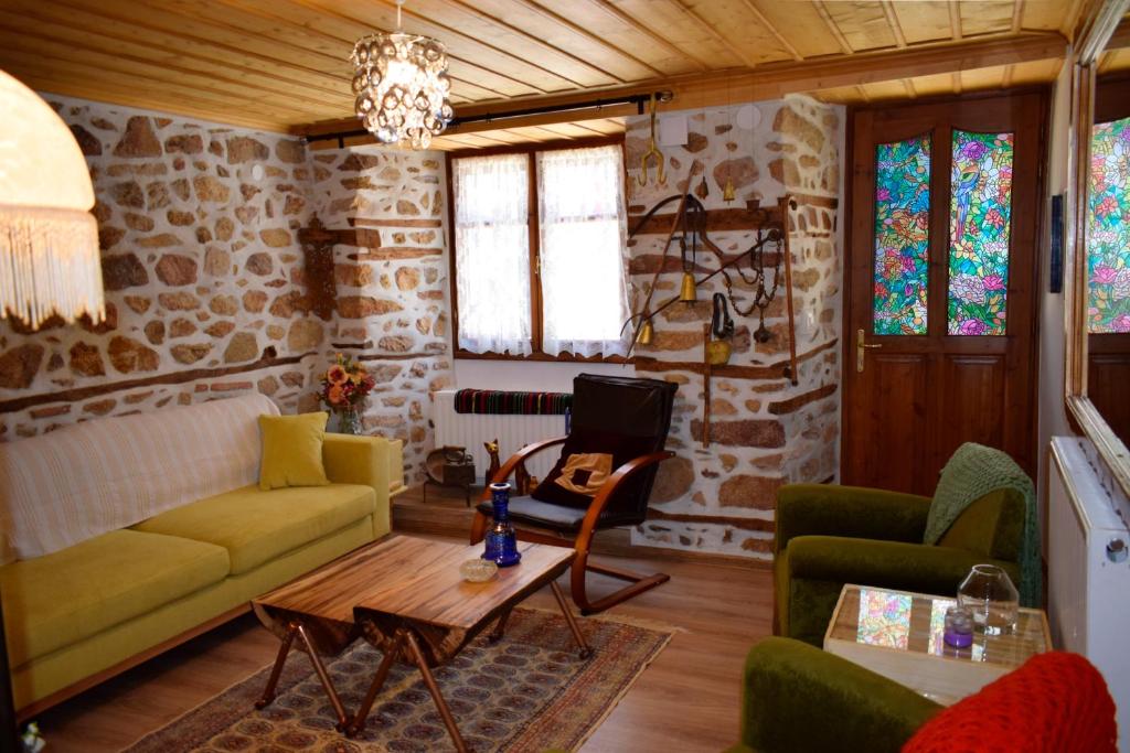 a living room with a couch and a table at Renovated Old Manor House With Yard in Arnaia