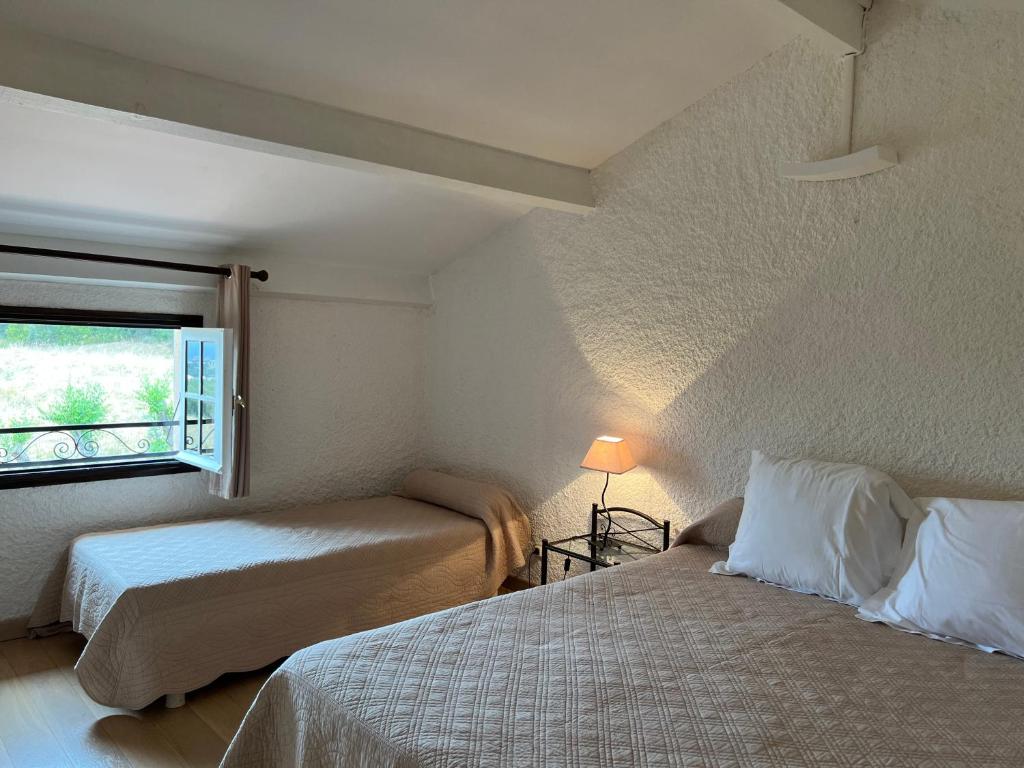 une chambre avec deux lits et une fenêtre dans l'établissement Résidence Marie Diane - Duplex Coté Mer E, à Propriano