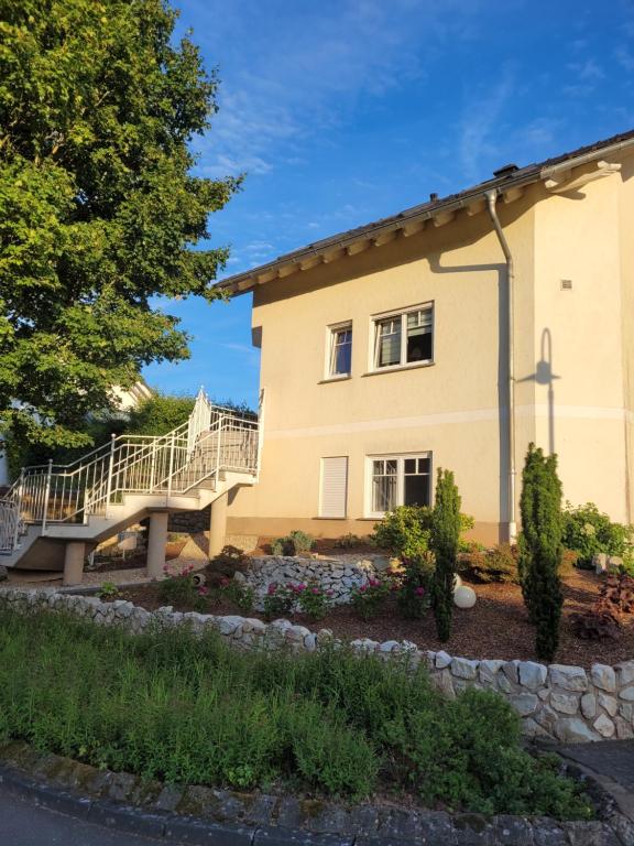 a house with a staircase in front of it at Ferienwohnung MIA in Flußbach