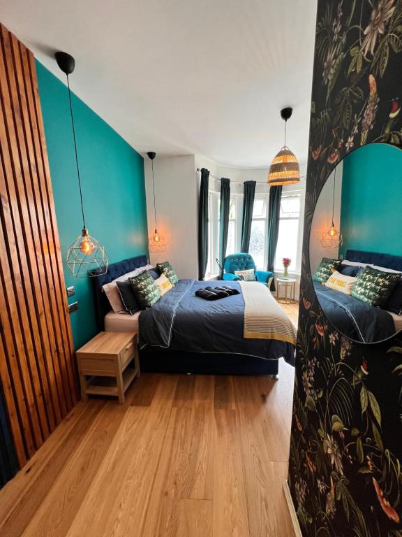 a bedroom with a bed and a mirror at Flamingo Lodge in Torquay
