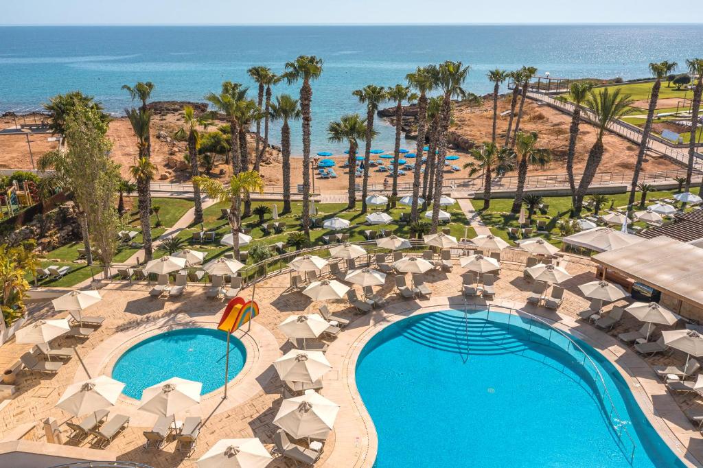 an aerial view of a resort with a swimming pool and the beach at Louis Althea Beach in Protaras