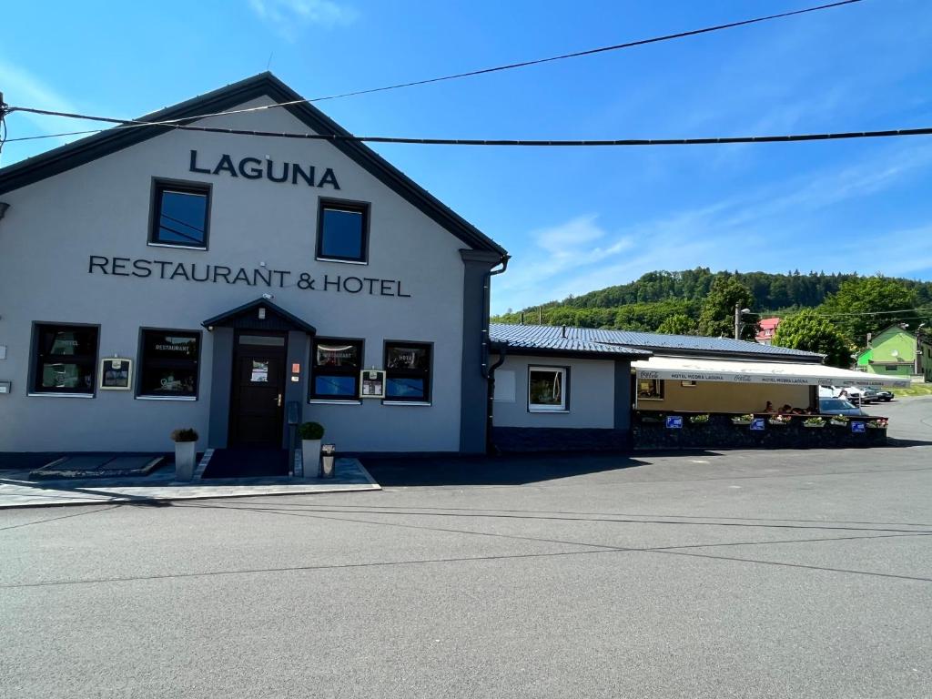 a white building with a restaurant and hotel at LAGUNA Hotel & Restaurant in Přimda
