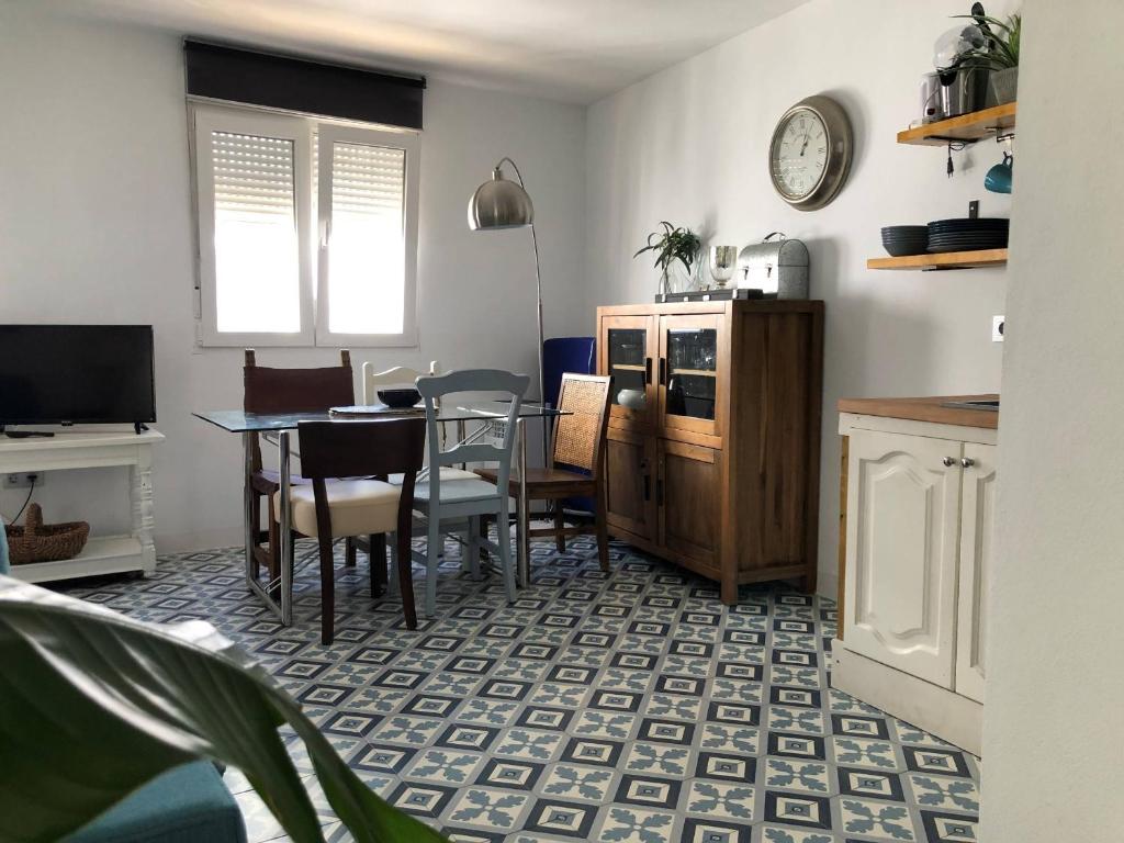 a kitchen with a table and chairs and a dining room at ABA DALÍ in Conil de la Frontera