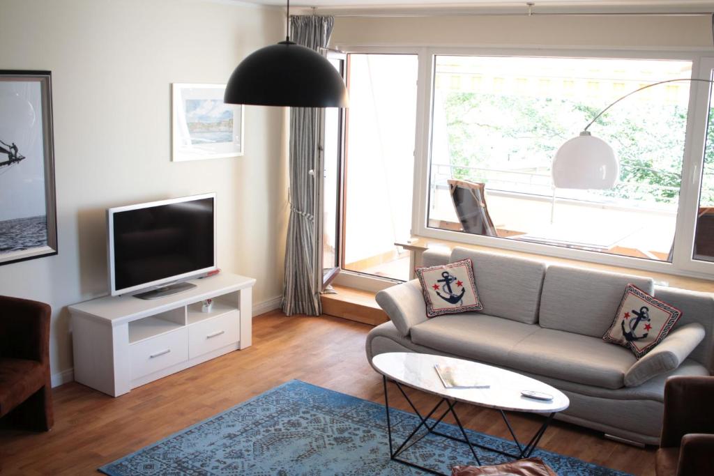 sala de estar con sofá y TV en fewo1846 - EastSide - komfortables Apartment im 2 OG mit Balkon und TG-Stellplatz en Flensburg