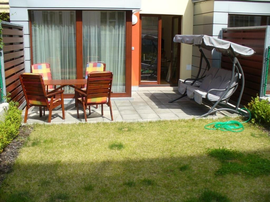 a patio with a table and chairs and an umbrella at Garden apartment with garage in central Prague in Prague