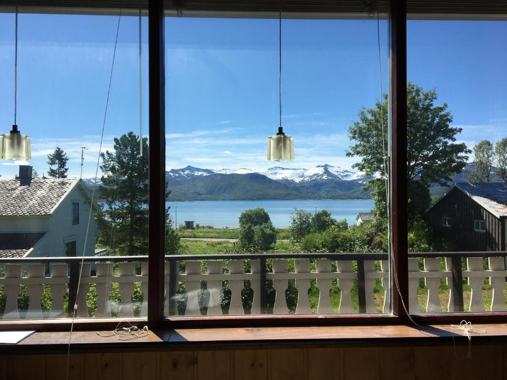 a view from a window of a lake and mountains at Koselig hus med parkeringsplass in Skaland