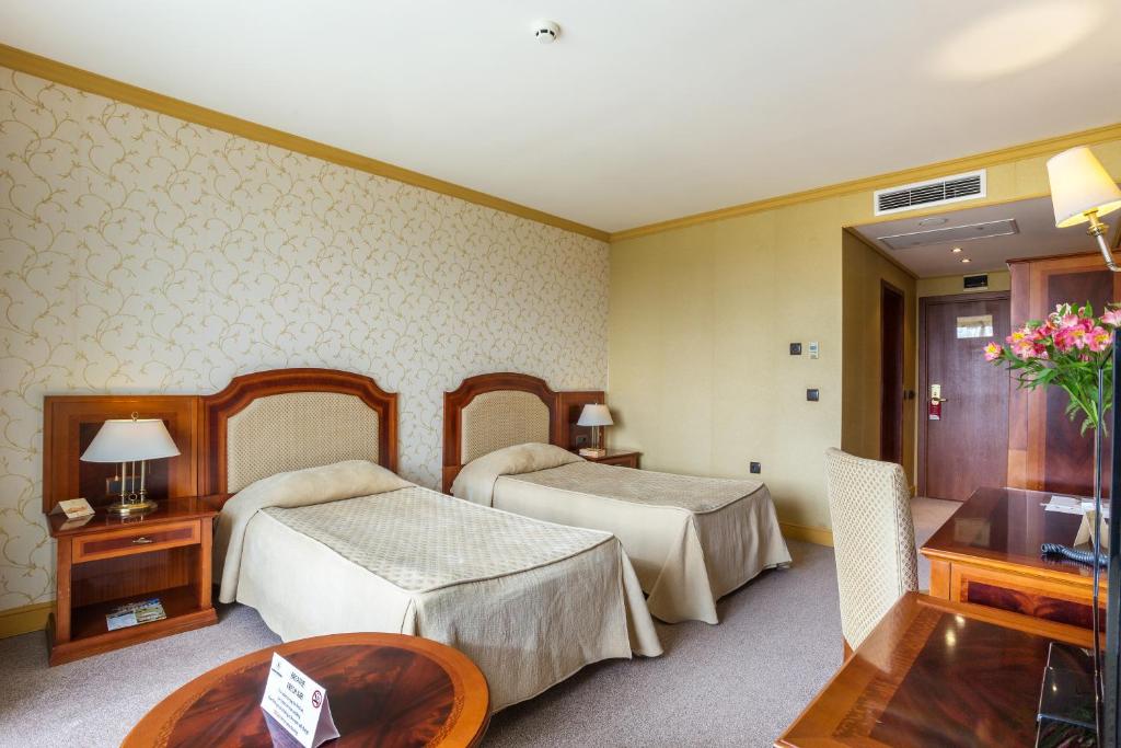 Postel nebo postele na pokoji v ubytování Romance Hotel and Family Suites