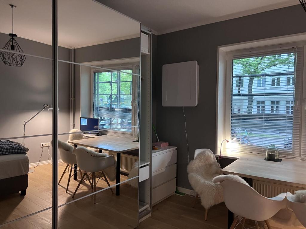 a room with a desk and a table with chairs at Bett 4 you Hamburg-Alster in Hamburg
