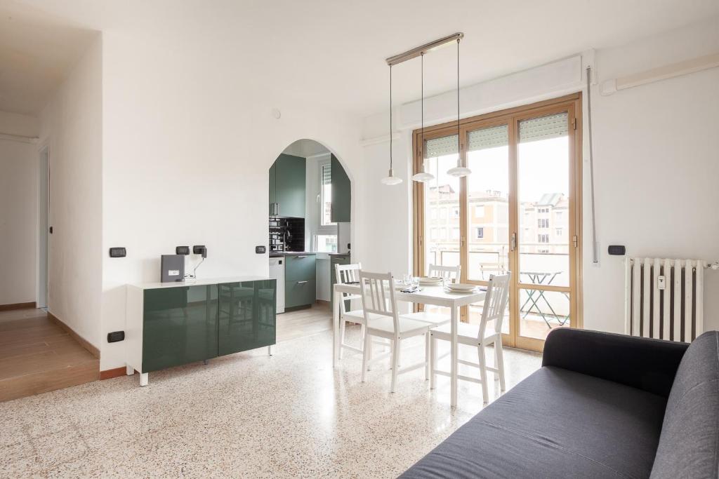 cocina y sala de estar con mesa y sillas en Spazioso appartamento - City Life - Fiera Milano - Alcuino 5, en Milán
