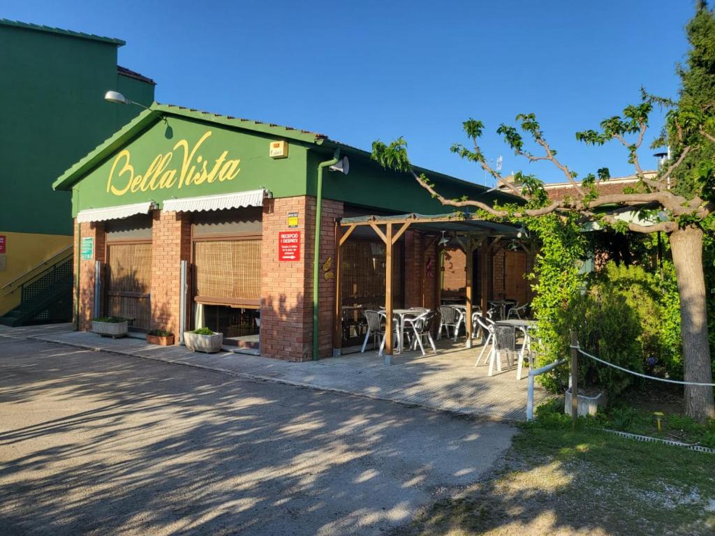 um restaurante com mesas e cadeiras fora dele em Alberg Restaurant Bellavista em Santa Pau