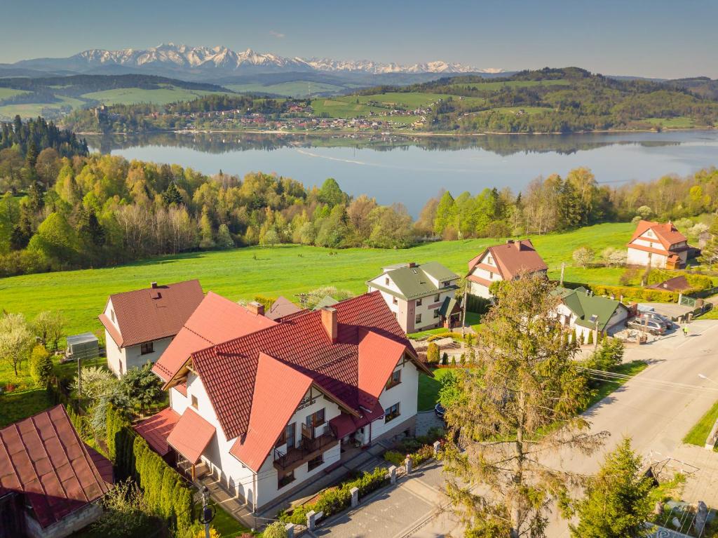 an aerial view of a house with a lake at Kurpielówka in Czorsztyn