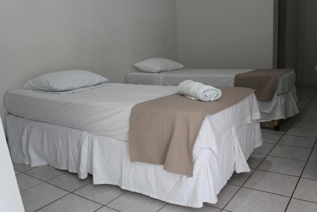 Cama ou camas em um quarto em Pousada Cecosne
