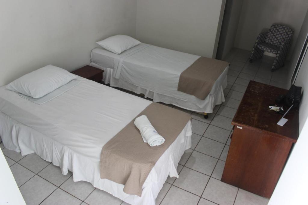 Cama ou camas em um quarto em Pousada Cecosne