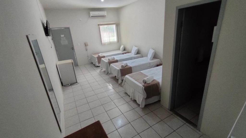 Cama ou camas em um quarto em Pousada Cecosne