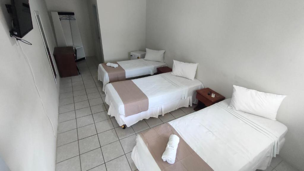 Cama ou camas em um quarto em Pousada Cecosne