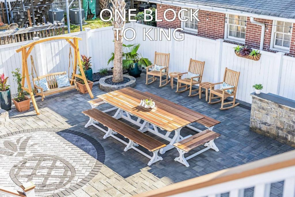 Stunning Secret Courtyard - 1 BLOCK TO KING في تشارلستون: طاولة وكراسي خشبية على الفناء