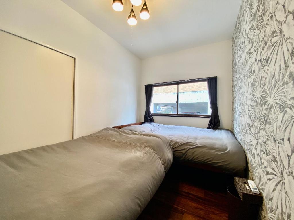 Postel nebo postele na pokoji v ubytování ARS HOTEL Utsunomiya フロア貸切