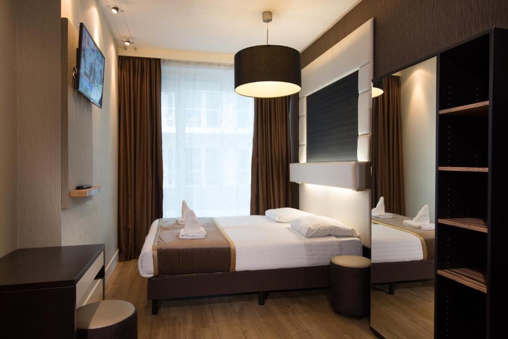 Voodi või voodid majutusasutuse Hotel Mosaic City Centre toas