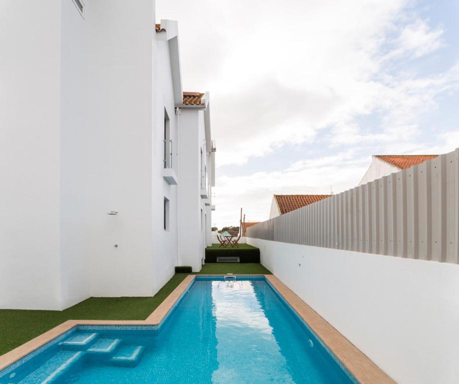a swimming pool in the backyard of a house at Sport Hotel A Seleção in Setúbal