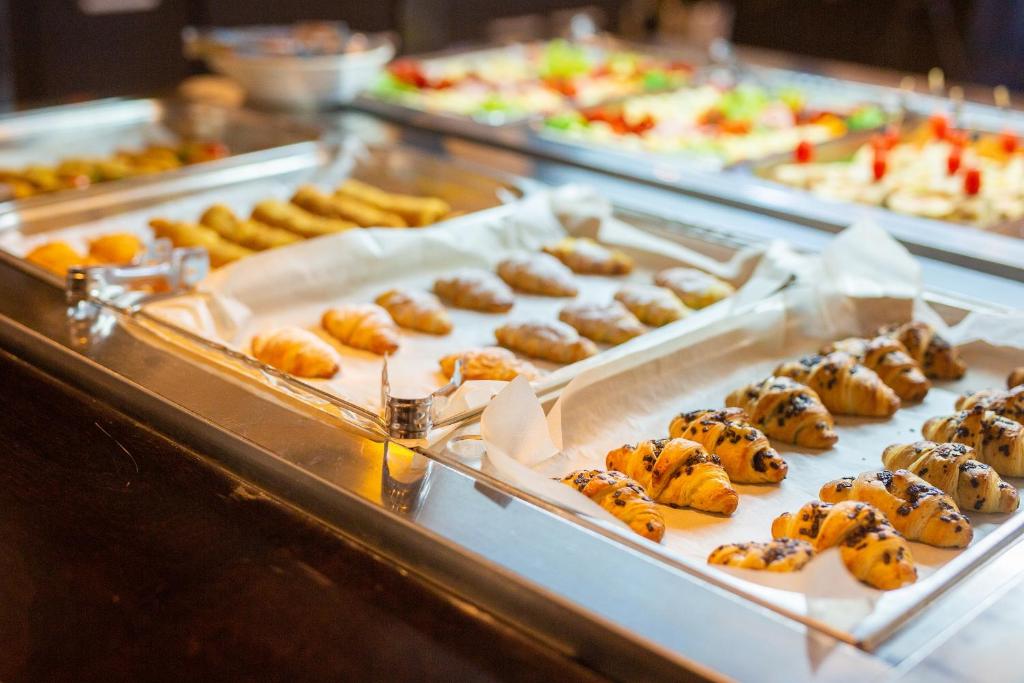 a display case with many different types of pastries at Hotel Bor in Krk