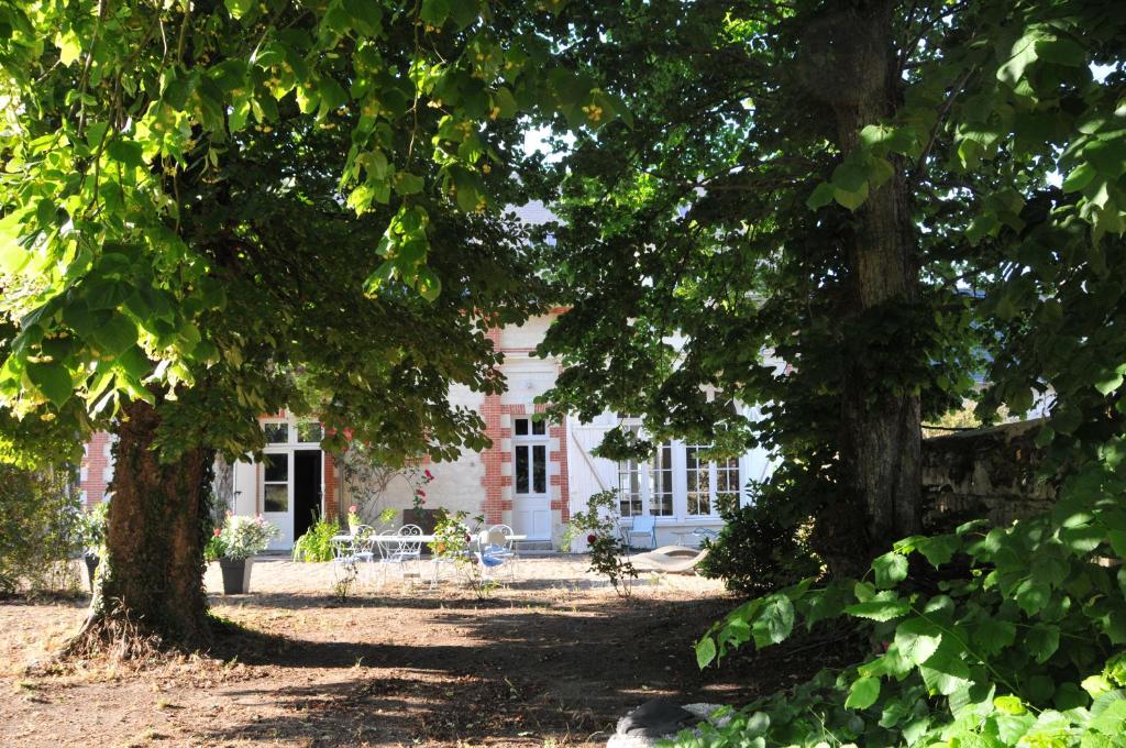 dom z dwoma drzewami przed nim w obiekcie LA PETITE BIJOUTERIE - GITE 5 Personnes w mieście Brain-sur-Allonnes