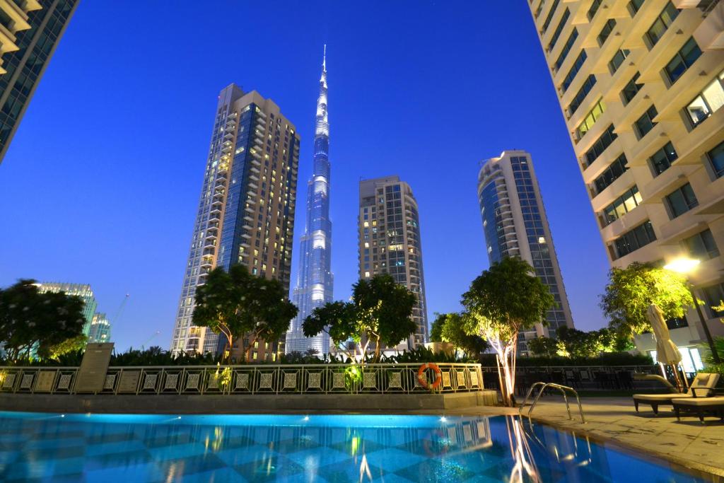 a pool in a city with tall buildings at Vacation Bay - 29 Boulevard Downtown in Dubai