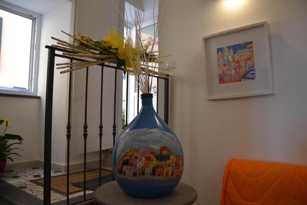 a blue vase sitting on a table in a room at Terra Murata Boutique b&b in Procida