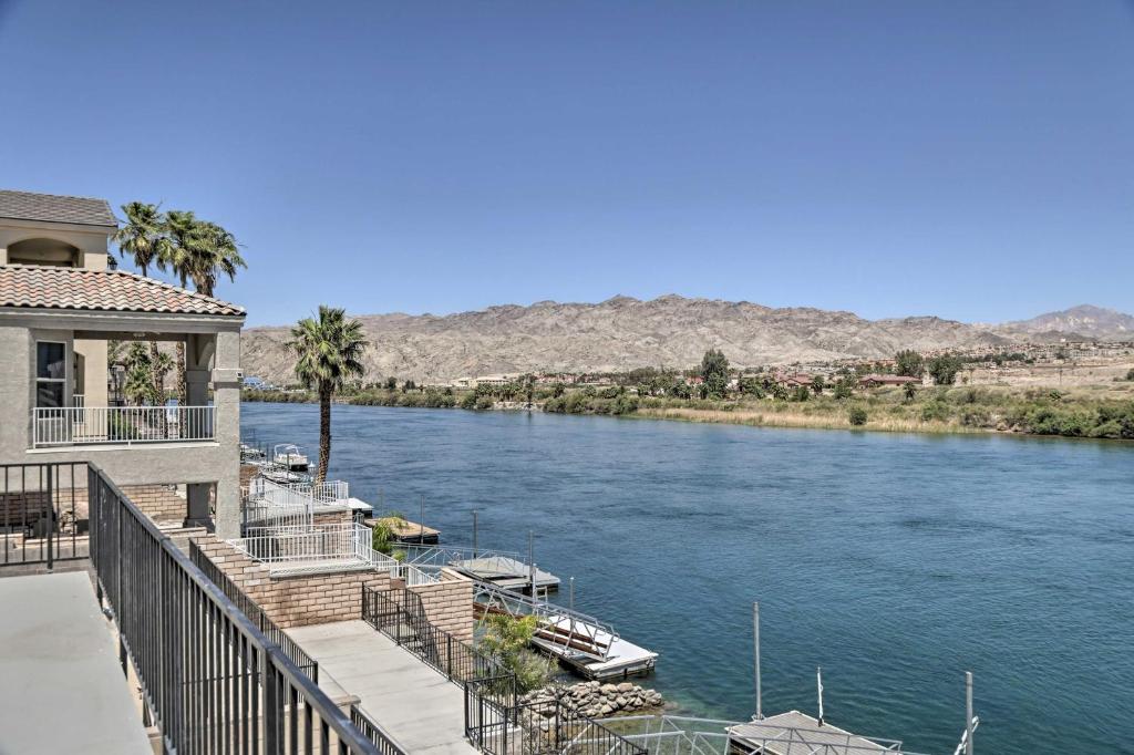 a view of a river with a house and boats at Riverfront Bullhead City Home with Private Dock in Bullhead City