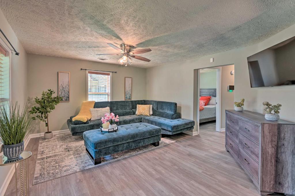 a living room with a couch and a ceiling fan at Quaint Downtown Murfreesboro Cottage with Lush Yard in Murfreesboro