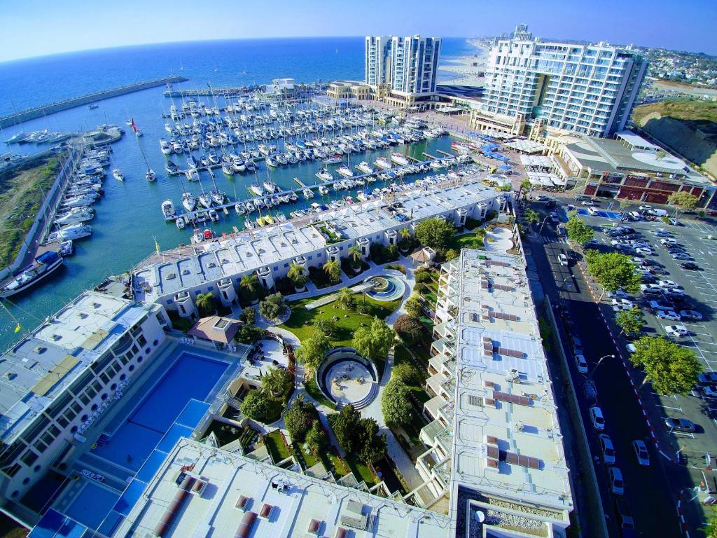 an aerial view of a marina next to the ocean at Israel Marina Village, Garden Vacation Apartment in Herzelia 