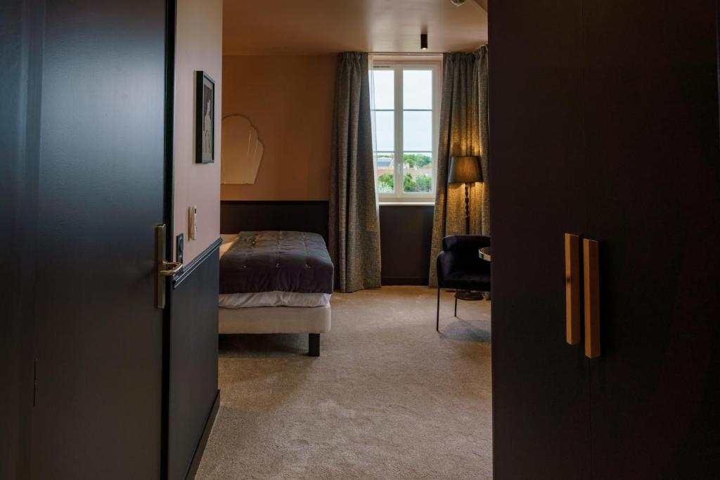 Posteľ alebo postele v izbe v ubytovaní Hotel de la Plage