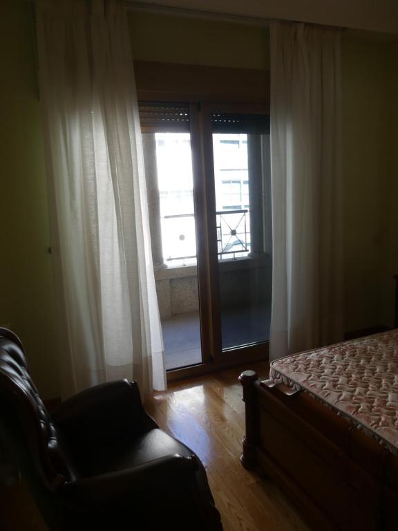 A bed or beds in a room at Apartamentos Villa Nustre